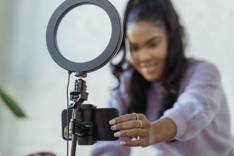A lady setting up her phone as a preparation for influencer campaigns in Ghana